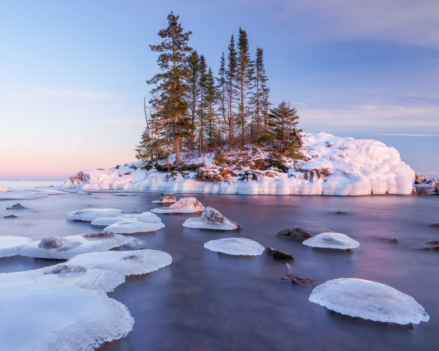 Image of a small island with snow at sunset